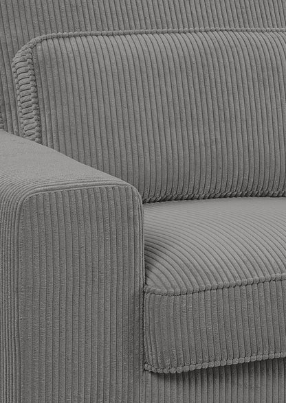 Nahaufnahme Ecksofa: grauer Cord-Bezug, Kissennaht und gepolsterte Seitenwange