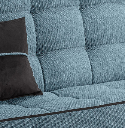 Polsterdetail am Schlafsofa: blaue Stoffoberfläche mit Quadersteppung und schwarzem Kissen