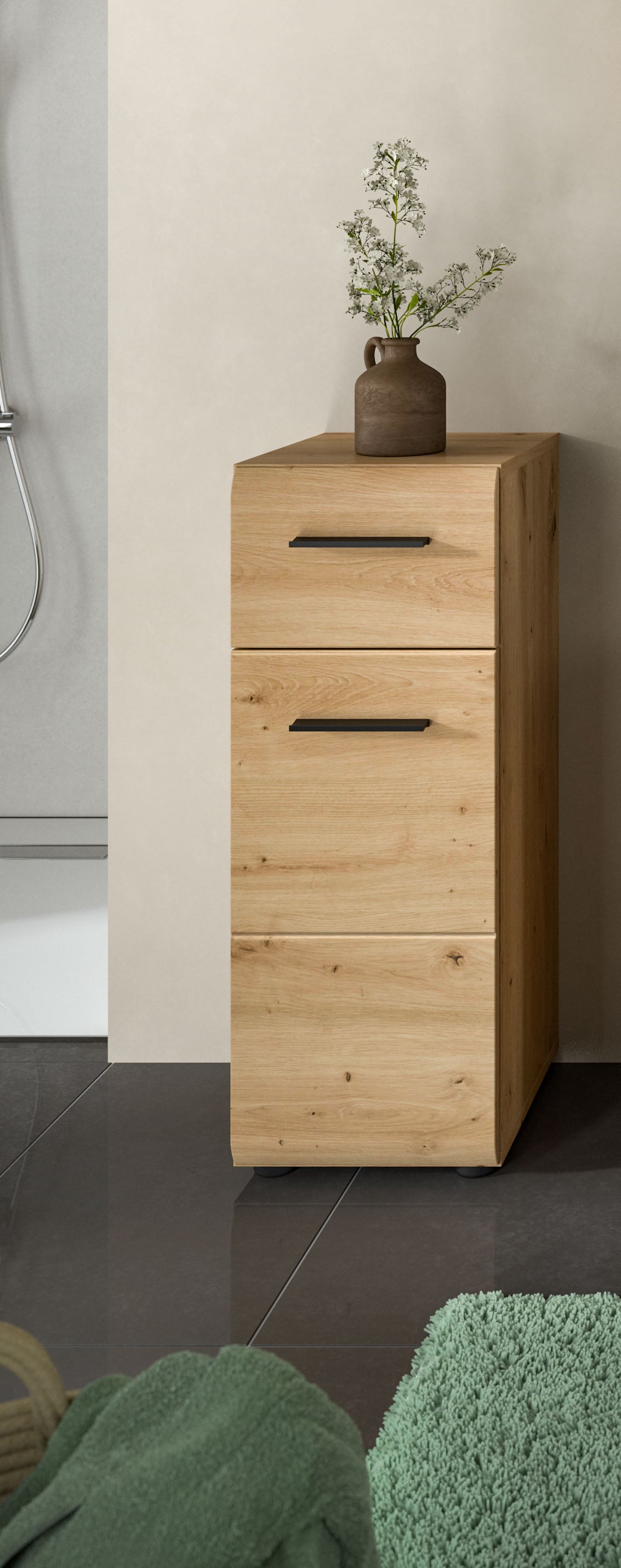 Schmaler Badezimmerschrank aus hellem Holz mit zwei Schubladen.