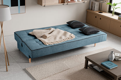 Schlafsofa mit Stoffbezug in Blau, aufgeklappt als Bett, mit zwei dunklen Kissen